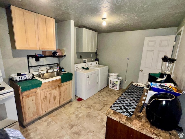 173 W Dimaggio Dr N, Tooele, UT 84074 - clothes washing area featuring a sink, cabinet space, separate washer and dryer, and a textured ceiling