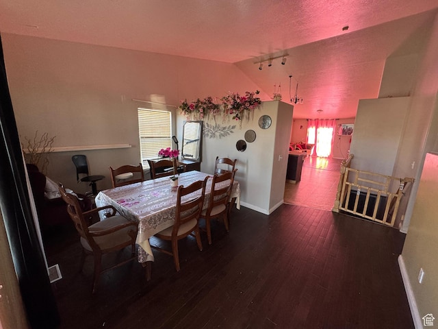 173 W Dimaggio Dr N, Tooele, UT 84074 - dining room featuring plenty of natural light, baseboards, lofted ceiling, and wood finished floors