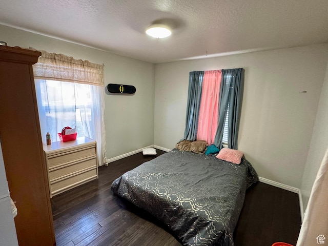 173 W Dimaggio Dr N, Tooele, UT 84074 - bedroom with dark wood finished floors, a textured ceiling, and baseboards