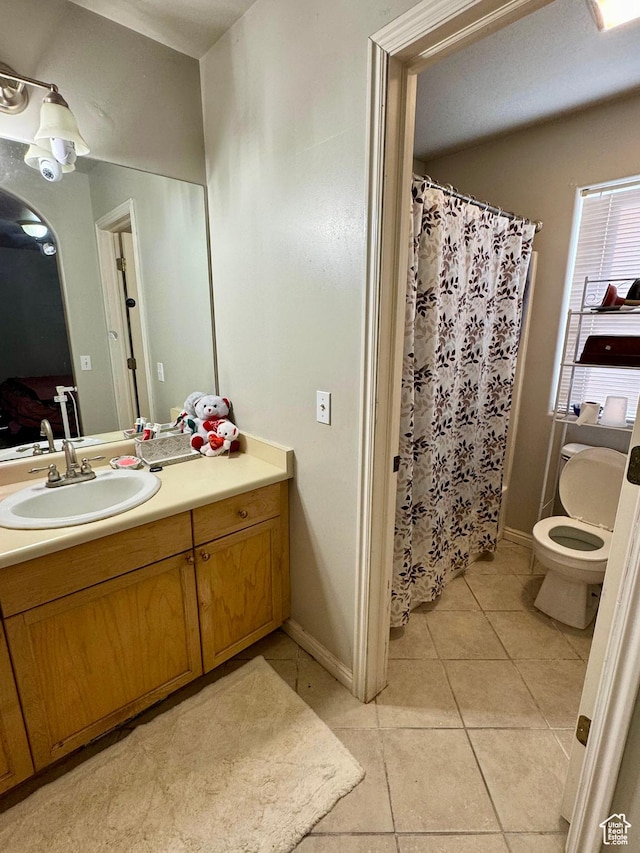 173 W Dimaggio Dr N, Tooele, UT 84074 - full bathroom featuring baseboards, toilet, a shower with shower curtain, tile patterned floors, and vanity