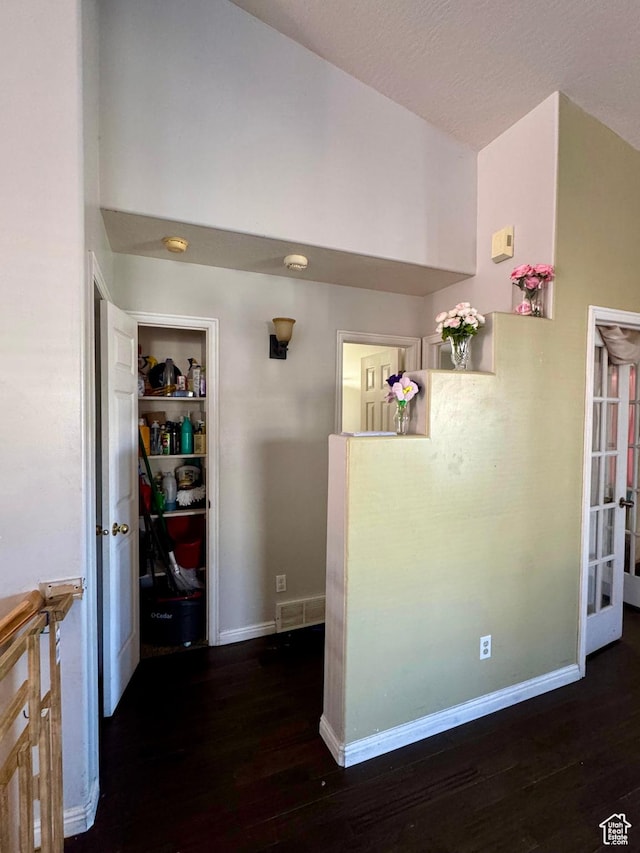 173 W Dimaggio Dr N, Tooele, UT 84074 - hallway with visible vents, dark wood-type flooring, baseboards, and vaulted ceiling