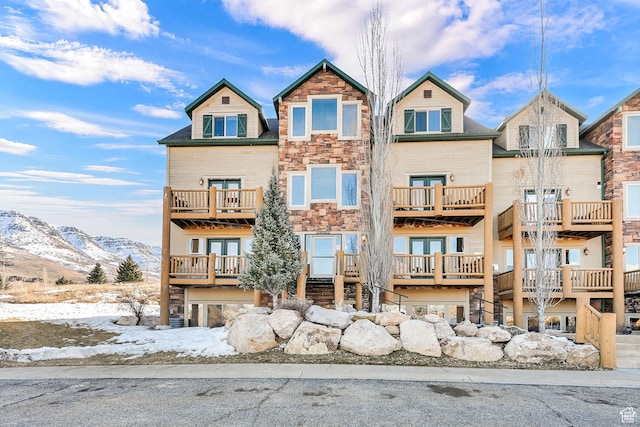 view of front of property with stone siding and a mountain view