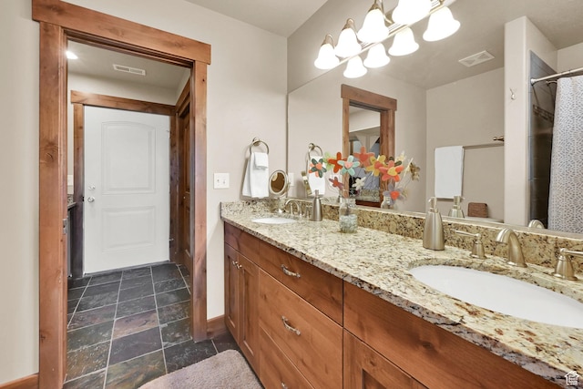 3518 N Moose Hollow Dr Unit 1402, Eden, UT 84310 - bathroom featuring stone finish flooring, double vanity, visible vents, and a sink
