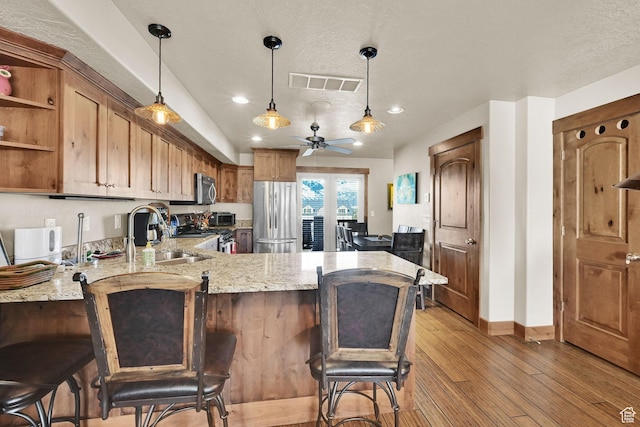 3518 N Moose Hollow Dr Unit 1402, Eden, UT 84310 - kitchen featuring a peninsula, visible vents, ceiling fan, light wood finished floors, and appliances with stainless steel finishes