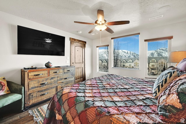 3518 N Moose Hollow Dr Unit 1402, Eden, UT 84310 - bedroom featuring visible vents, multiple windows, wood finished floors, and a textured ceiling