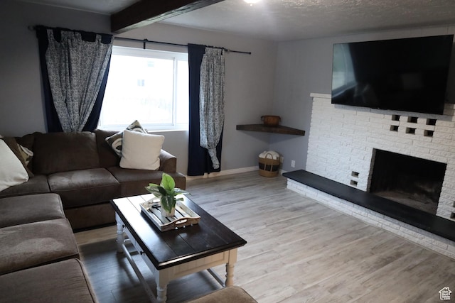 33 W 400 N, Orem, UT 84057 - living room with wood finished floors, baseboards, beam ceiling, a textured ceiling, and a brick fireplace