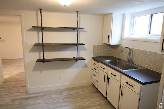 33 W 400 N, Orem, UT 84057 - kitchen with a sink, open shelves, dark countertops, backsplash, and light wood-style floors