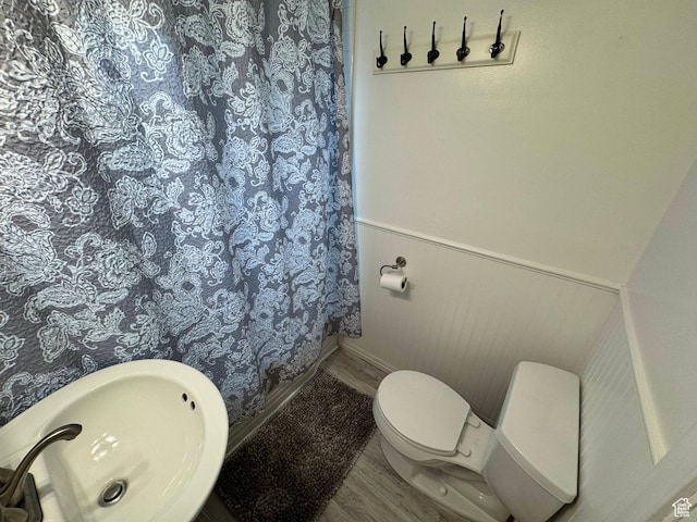 33 W 400 N, Orem, UT 84057 - full bathroom featuring toilet, a sink, curtained shower, wood finished floors, and wainscoting