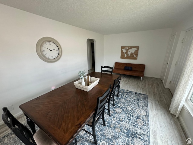 33 W 400 N, Orem, UT 84057 - dining room featuring arched walkways, a textured ceiling, baseboards, and wood finished floors