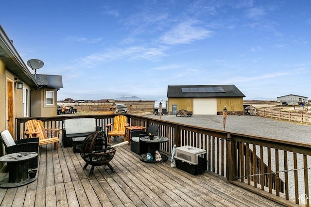 deck with an outbuilding and a fire pit