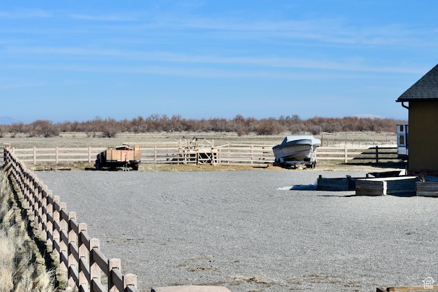 view of yard with a rural view and fence