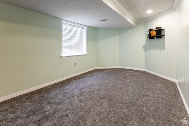 basement with visible vents, baseboards, carpet floors, a textured ceiling, and crown molding