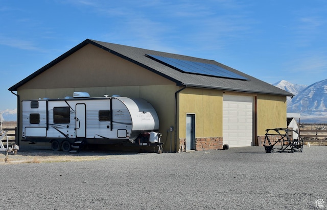 exterior space featuring a mountain view and solar panels