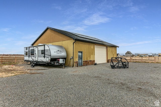 view of outbuilding featuring an outdoor structure and fence