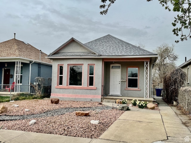 1022 W 400 N, Salt Lake City, UT 84116 - bungalow-style home with fence, stucco siding, a porch, and roof with shingles