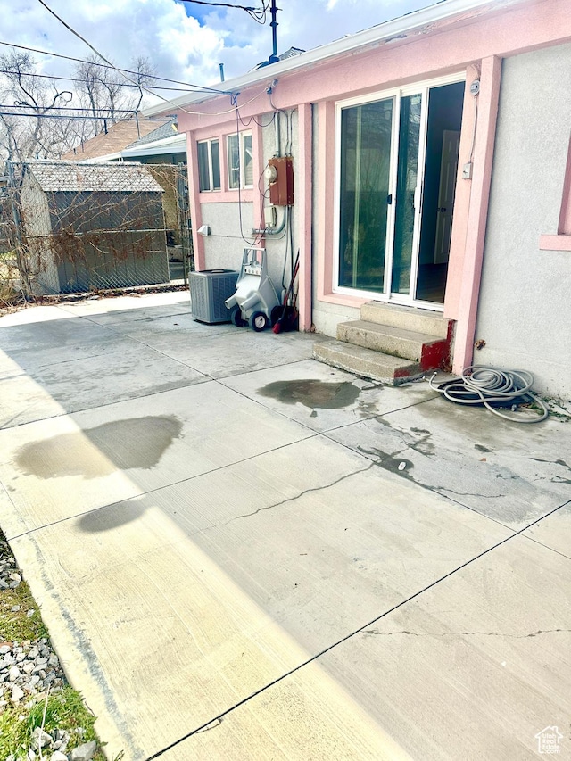 1022 W 400 N, Salt Lake City, UT 84116 - view of patio with an outbuilding, central AC unit, a storage unit, and entry steps