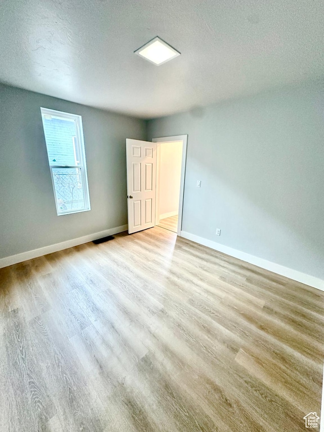 1022 W 400 N, Salt Lake City, UT 84116 - spare room with baseboards, wood finished floors, and a textured ceiling