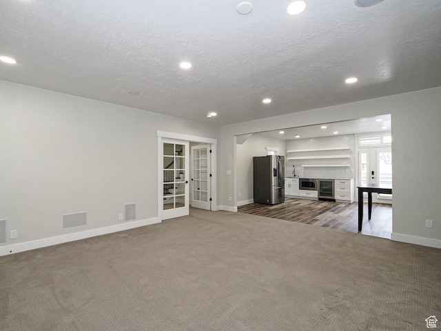 1146 W Jordan River Dr, South Jordan, UT 84095 - unfurnished living room featuring visible vents, recessed lighting, french doors, carpet, and baseboards