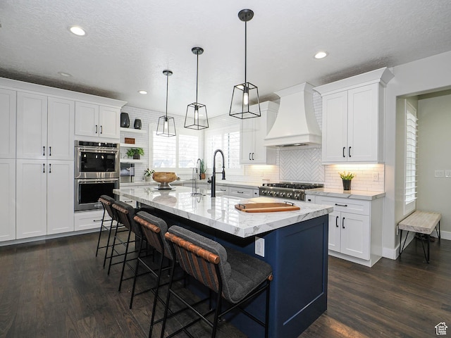 1146 W Jordan River Dr, South Jordan, UT 84095 - kitchen with dark wood-type flooring, a kitchen breakfast bar, stainless steel double oven, stove, and custom exhaust hood