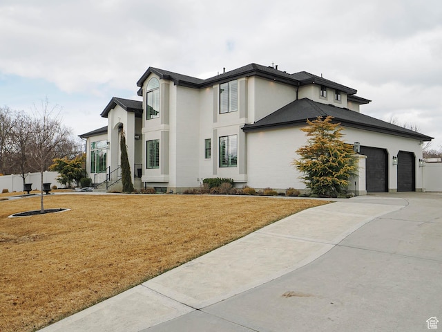 1146 W Jordan River Dr, South Jordan, UT 84095 - view of front of property featuring a front yard, fence, driveway, stucco siding, and a garage