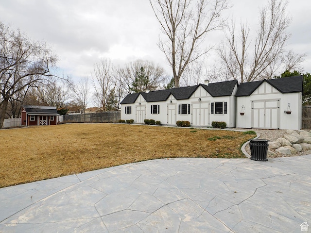 1146 W Jordan River Dr, South Jordan, UT 84095 - modern inspired farmhouse featuring a front yard, fence, roof with shingles, an outdoor structure, and a storage shed