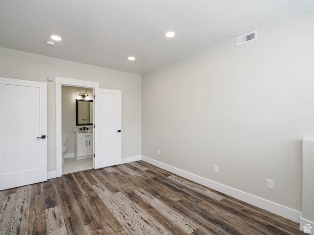 1146 W Jordan River Dr, South Jordan, UT 84095 - unfurnished bedroom with wood finished floors, baseboards, visible vents, ensuite bath, and recessed lighting