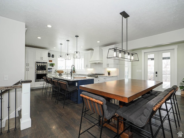 1146 W Jordan River Dr, South Jordan, UT 84095 - dining space featuring recessed lighting, french doors, a textured ceiling, and dark wood finished floors