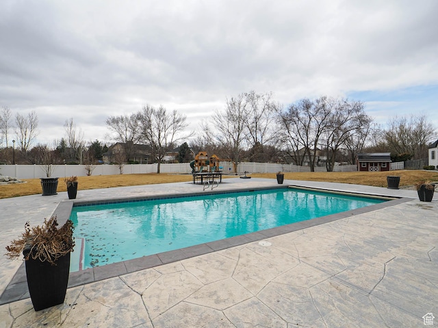 1146 W Jordan River Dr, South Jordan, UT 84095 - view of swimming pool featuring a fenced in pool, a patio, a lawn, and a fenced backyard