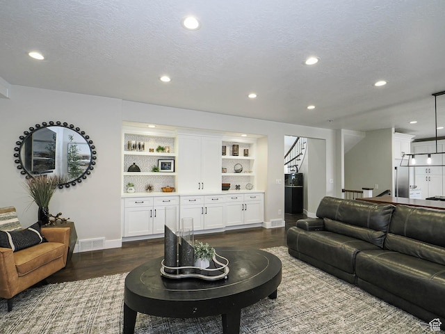 1146 W Jordan River Dr, South Jordan, UT 84095 - living room featuring recessed lighting, visible vents, a textured ceiling, and dark wood-style floors