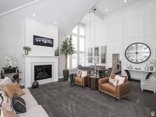 1146 W Jordan River Dr, South Jordan, UT 84095 - living area with dark wood-style floors, visible vents, an inviting chandelier, a towering ceiling, and a glass covered fireplace