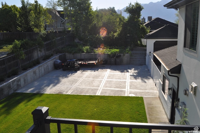 1146 W Jordan River Dr, South Jordan, UT 84095 - view of yard with stairs, a patio area, a fenced backyard, and a mountain view