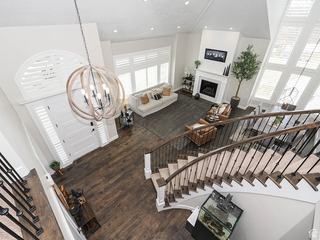 1146 W Jordan River Dr, South Jordan, UT 84095 - interior space featuring baseboards, recessed lighting, a fireplace, an inviting chandelier, and wood finished floors