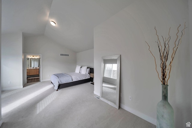 869 S Washington St Unit 101, Salt Lake City, UT 84101 - carpeted bedroom featuring vaulted ceiling, baseboards, visible vents, and ensuite bathroom