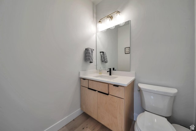869 S Washington St Unit 101, Salt Lake City, UT 84101 - bathroom with baseboards, toilet, wood finished floors, and vanity