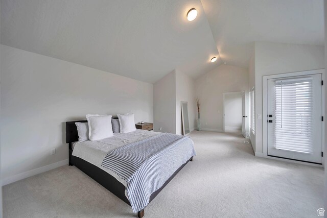 869 S Washington St Unit 101, Salt Lake City, UT 84101 - bedroom featuring lofted ceiling, baseboards, and light carpet