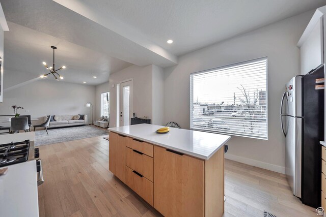 869 S Washington St Unit 101, Salt Lake City, UT 84101 - kitchen featuring light brown cabinets, light wood-style flooring, freestanding refrigerator, modern cabinets, and a center island