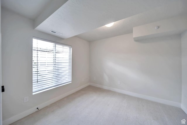 869 S Washington St Unit 101, Salt Lake City, UT 84101 - spare room with visible vents, baseboards, carpet, and a textured ceiling