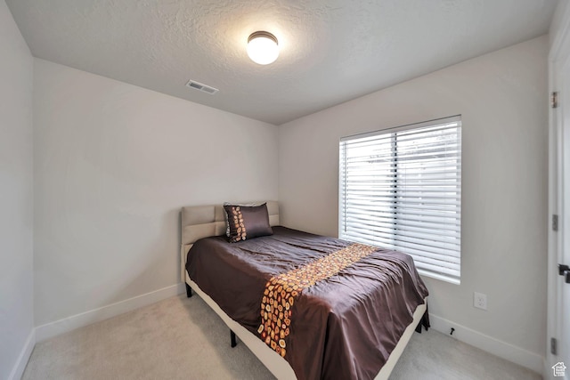 869 S Washington St Unit 101, Salt Lake City, UT 84101 - carpeted bedroom featuring visible vents, baseboards, and a textured ceiling
