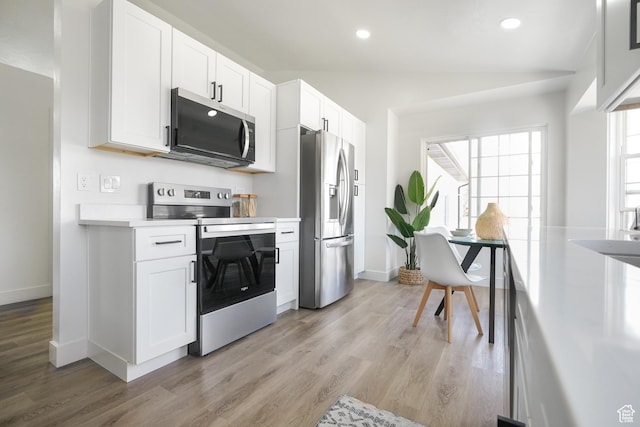 865 W 1800 N, Mapleton, UT 84664 - kitchen with stainless steel appliances, light wood finished floors, white cabinets, and light countertops