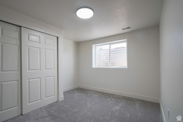 865 W 1800 N, Mapleton, UT 84664 - unfurnished bedroom featuring visible vents, a textured ceiling, a closet, carpet floors, and baseboards