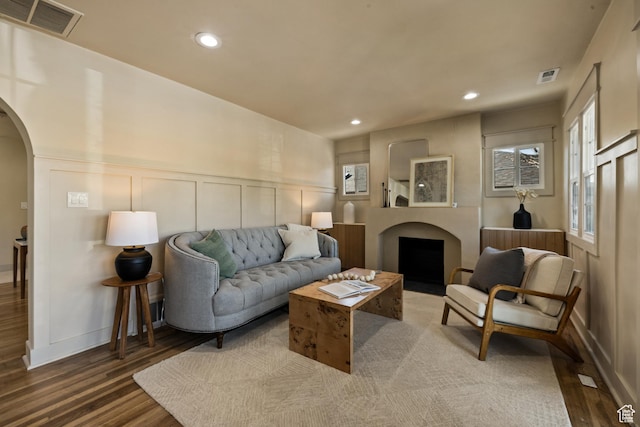 1444 E Sherman Ave, Salt Lake City, UT 84105 - living area featuring arched walkways, a decorative wall, visible vents, and wood finished floors