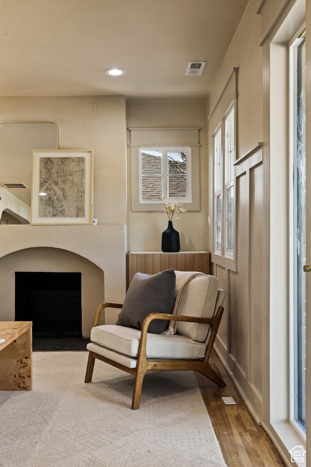1444 E Sherman Ave, Salt Lake City, UT 84105 - living area featuring a fireplace with flush hearth, visible vents, wood finished floors, and recessed lighting