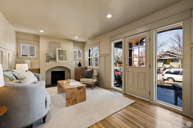 1444 E Sherman Ave, Salt Lake City, UT 84105 - living room featuring a decorative wall, light wood-style floors, a fireplace, and recessed lighting