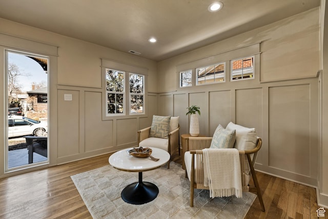 1444 E Sherman Ave, Salt Lake City, UT 84105 - living area featuring visible vents, recessed lighting, wood finished floors, and a decorative wall