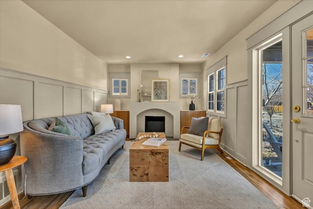 1444 E Sherman Ave, Salt Lake City, UT 84105 - living room featuring a fireplace, recessed lighting, wood finished floors, and a decorative wall