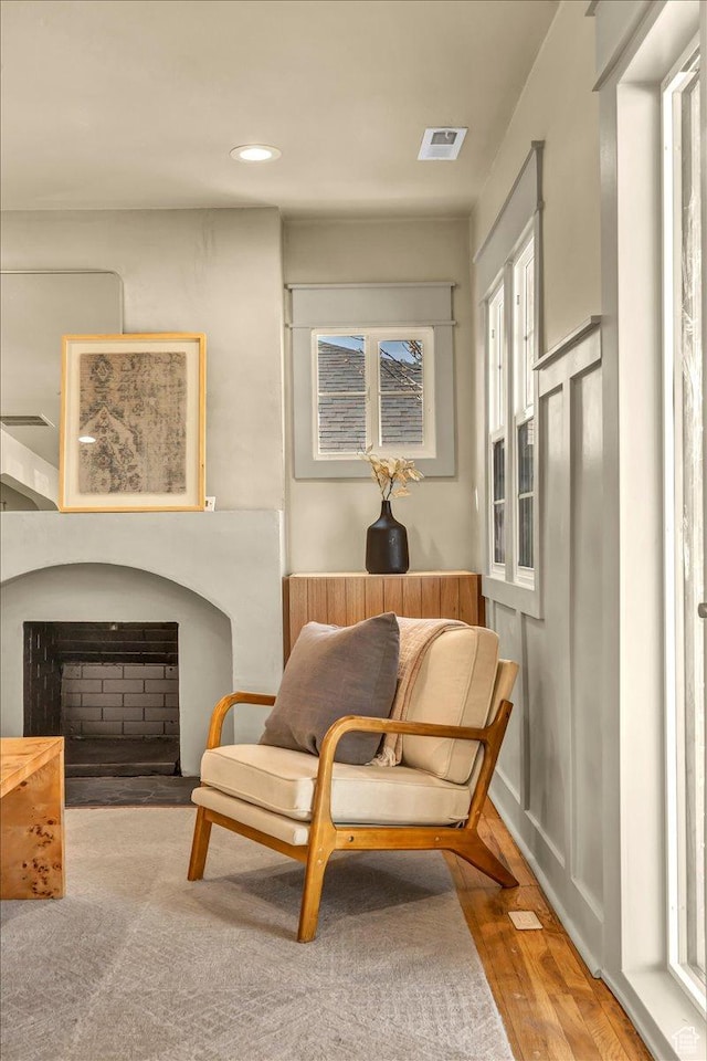 1444 E Sherman Ave, Salt Lake City, UT 84105 - sitting room featuring wood finished floors, recessed lighting, a fireplace, and visible vents
