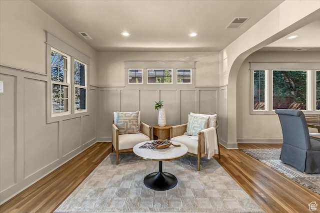 1444 E Sherman Ave, Salt Lake City, UT 84105 - living area with plenty of natural light, visible vents, arched walkways, and a decorative wall