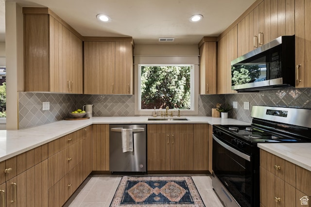 1444 E Sherman Ave, Salt Lake City, UT 84105 - kitchen with a sink, stainless steel appliances, light stone counters, and visible vents