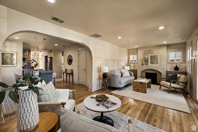 1444 E Sherman Ave, Salt Lake City, UT 84105 - living area featuring arched walkways, visible vents, recessed lighting, and wood finished floors