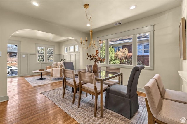 1444 E Sherman Ave, Salt Lake City, UT 84105 - dining room with wood finished floors, recessed lighting, arched walkways, a decorative wall, and wainscoting